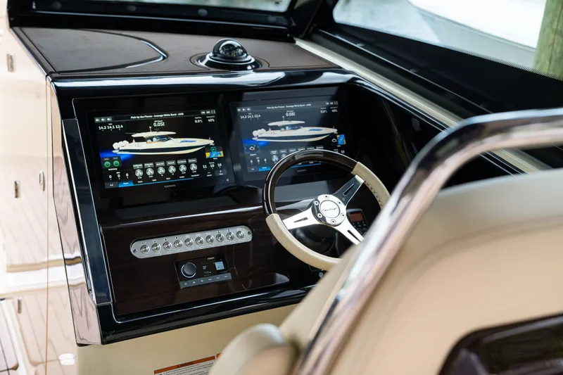 Slide: The Image of 2022 Chris-Craft Calypso 35 dashboard with dual displays and steering wheel. - 17