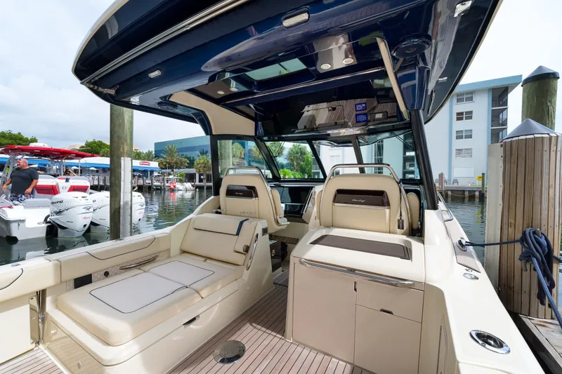 Slide: The Image of 2022 Chris-Craft Calypso 35 boat interior at marina, featuring luxurious seating and modern design. - 20
