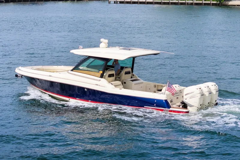 Slide: The Image of 2022 Chris-Craft Calypso 35 boat cruising on water with triple Mercury engines. - 9