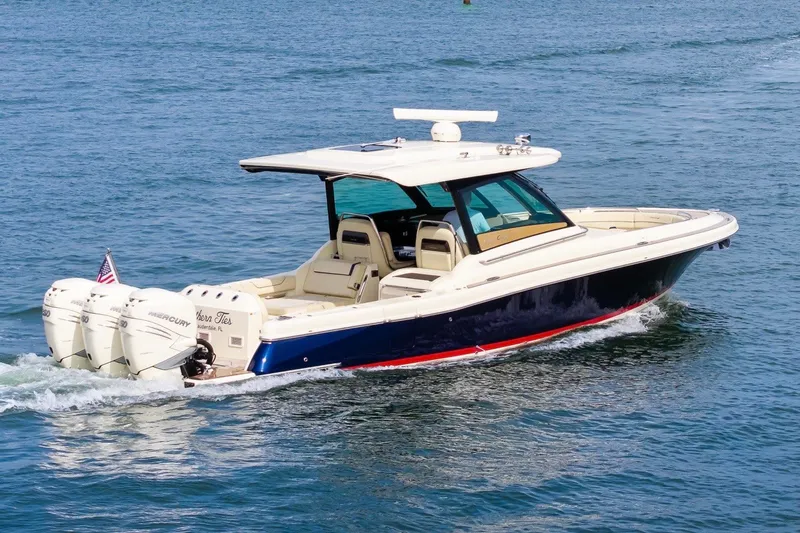 Slide: The Image of 2022 Chris-Craft Calypso 35 boat cruising on open water. - 2