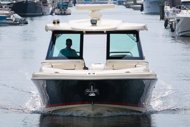 Slide: The Image of 2022 Chris-Craft Calypso 35 cruising in a marina, front view. - 12
