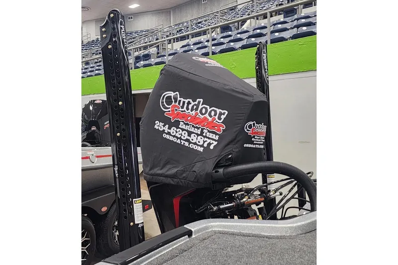 The Image of 2026 iKon LXE20 boat engine with Outdoor Specialties cover in a stadium setting. - 1