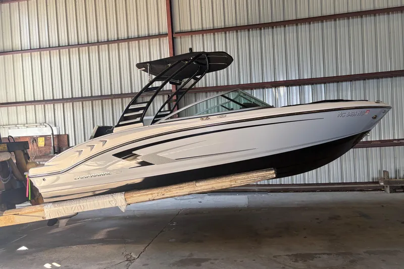 Slide: The Image of 2025 Chaparral 21 SSi boat in storage, side view, indoors. - 2