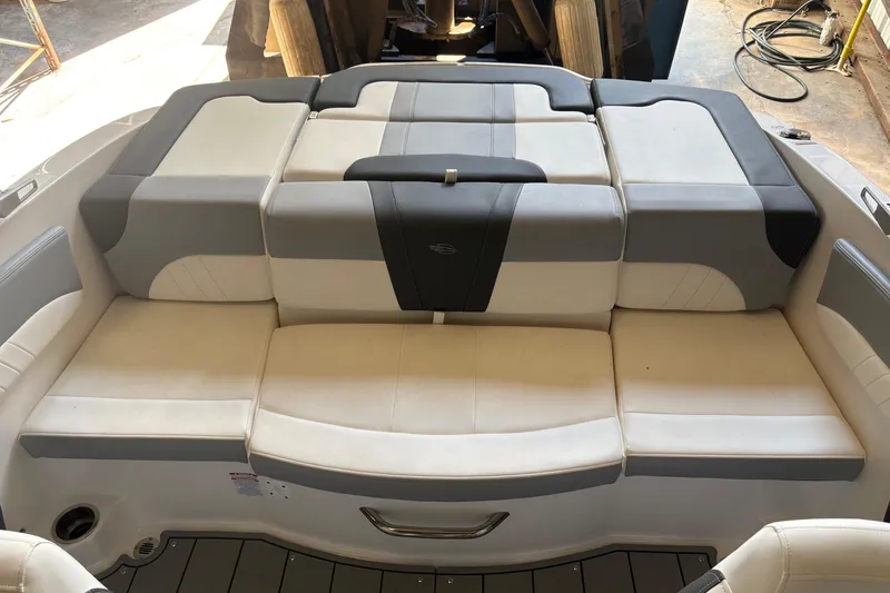 Slide: The Image of 2025 Chaparral 21 SSi boat interior with cushioned seating in gray and white. - 3