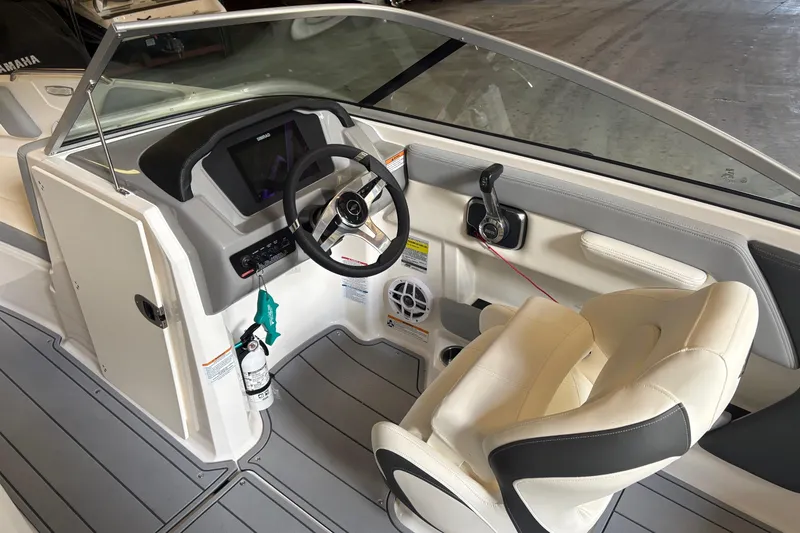 Slide: The Image of Interior view of 2025 Chaparral 21 SSi boat cockpit with steering wheel and controls. - 6