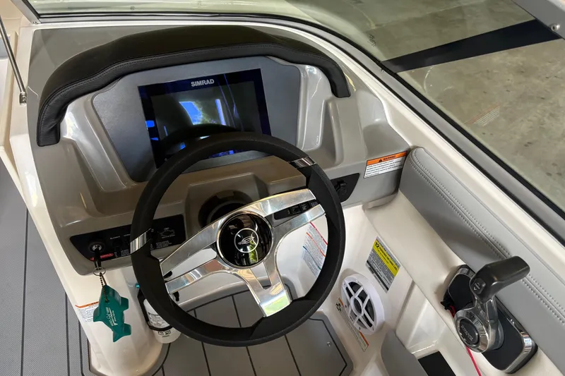 Slide: The Image of 2025 Chaparral 21 SSi boat dashboard with steering wheel and control panel. - 7