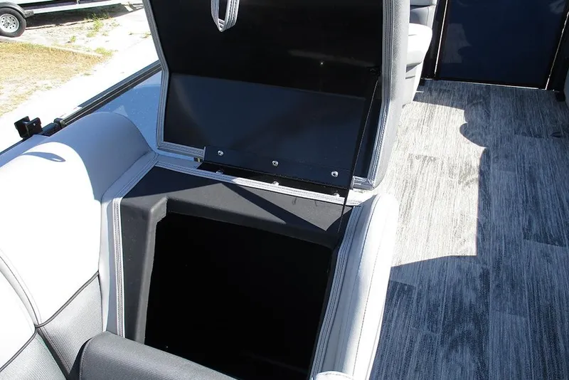 Slide: The Image of 2026 Bentley Pontoons Fish 240 N-Cruise storage compartment with open lid, showcasing interior space. - 18