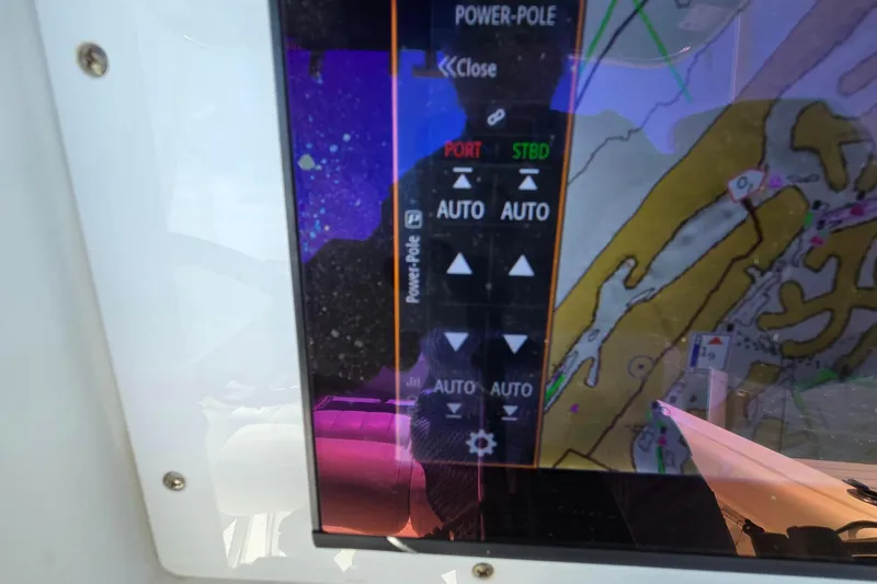 Slide: The Image of Close-up of a Sea Hunt Ultra 225 boat's navigation display, showing map and control options. - 10