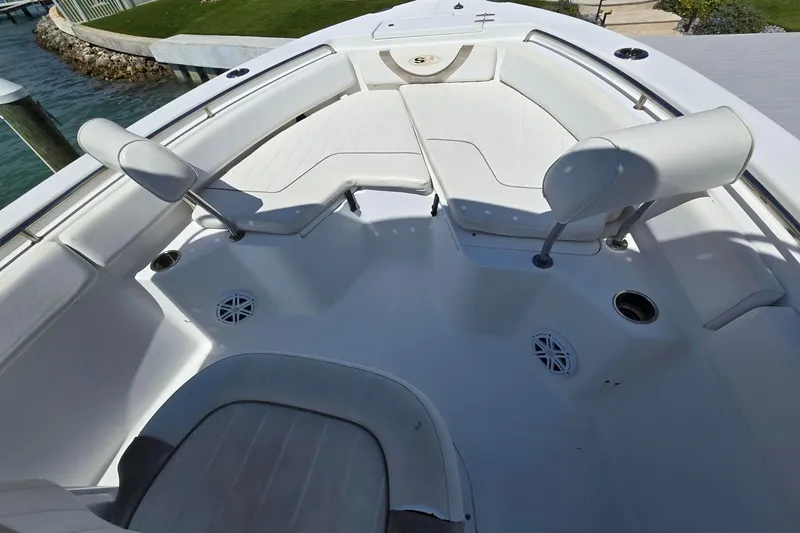 Slide: The Image of 2012 Sea Hunt Ultra 225 boat interior with white seating and cup holders. - 13