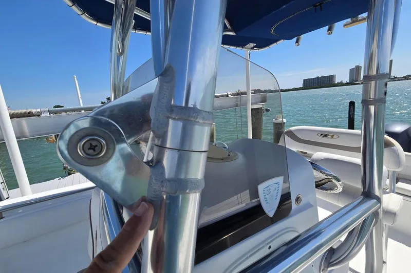 Slide: The Image of 2012 Sea Hunt Ultra 225 boat with stainless steel details, docked by the water. - 19