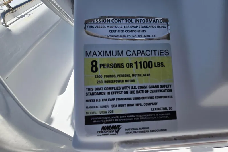 Slide: The Image of 2012 Sea Hunt Ultra 225 capacity label, 8 persons or 1100 lbs, safety compliance details. - 22