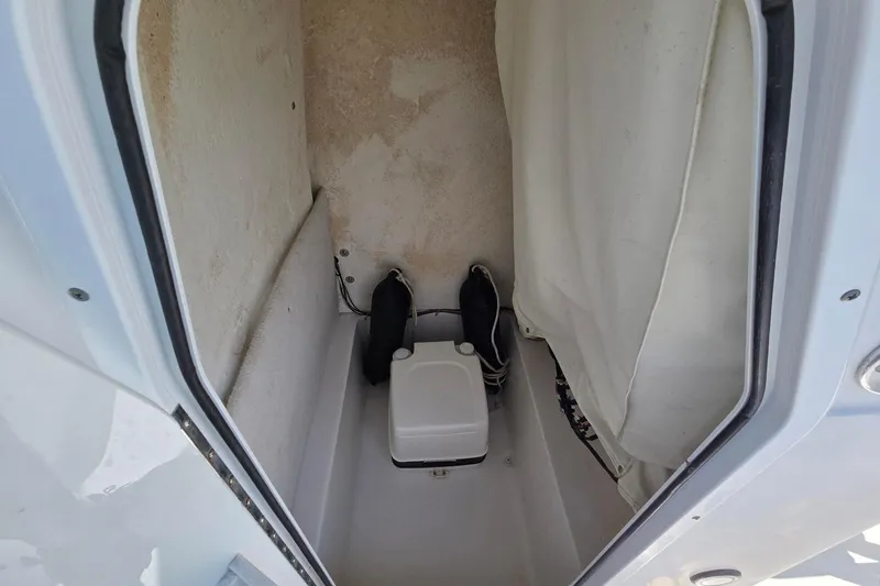 Slide: The Image of Interior view of a 2012 Sea Hunt Ultra 225 boat compartment with storage. - 23
