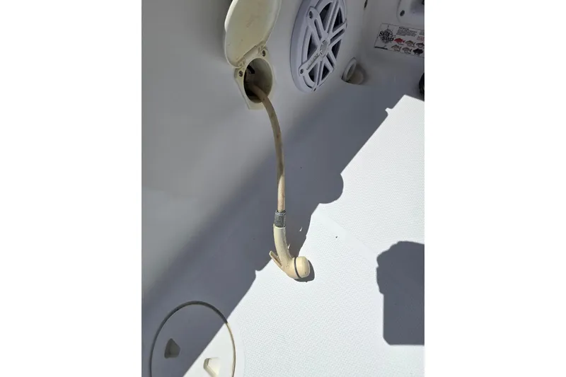 Slide: The Image of 2012 Sea Hunt Ultra 225 boat deck with hose and speaker detail. - 24