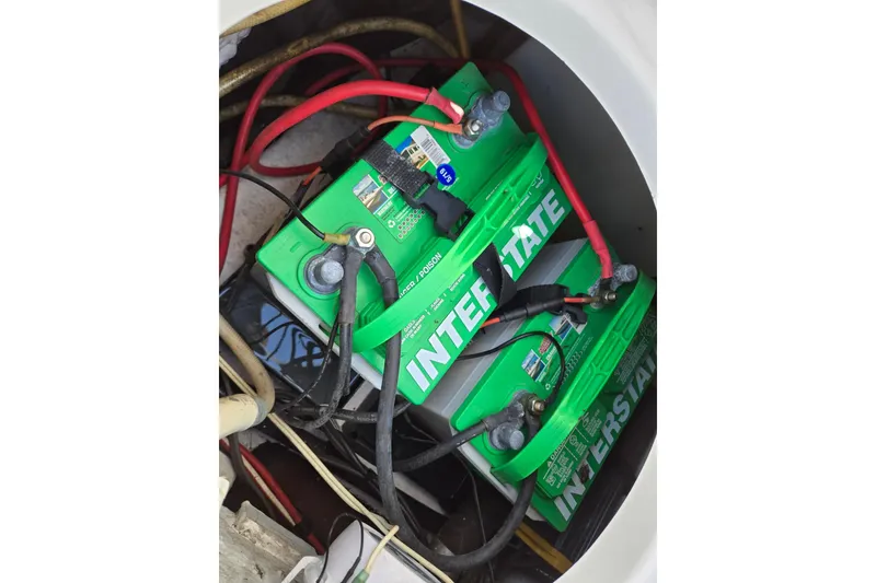 Slide: The Image of Interstate batteries in a 2012 Sea Hunt Ultra 225 boat, connected with red and black cables. - 26