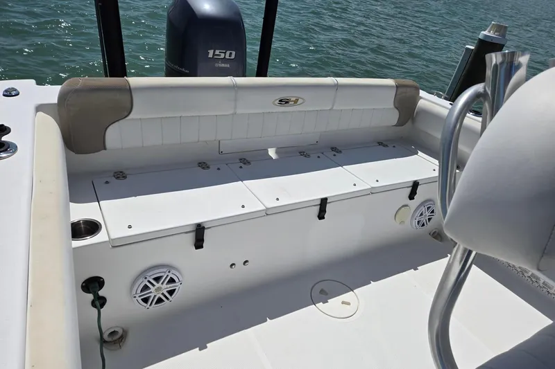 Slide: The Image of 2012 Sea Hunt Ultra 225 boat interior with Yamaha 150 engine, featuring seating and storage. - 28