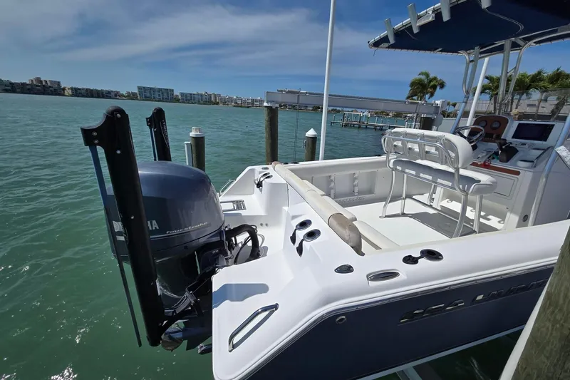 Slide: The Image of 2012 Sea Hunt Ultra 225 boat docked, featuring a Yamaha outboard motor and spacious seating. - 4
