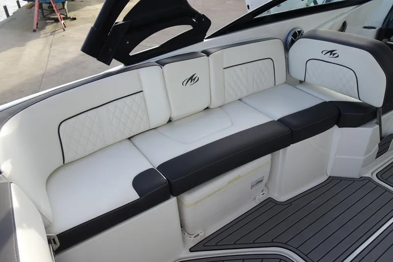 Slide: The Image of Luxurious seating on a 2017 Monterey M-65 boat, featuring elegant white and black upholstery. - 14