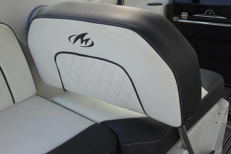 Slide: The Image of 2017 Monterey M-65 boat seat with black and white upholstery, featuring diamond stitching and logo. - 15