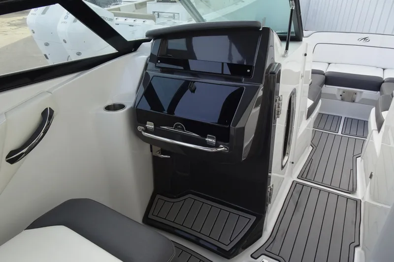 Slide: The Image of 2017 Monterey M-65 boat interior with sleek dashboard and modern seating. - 16