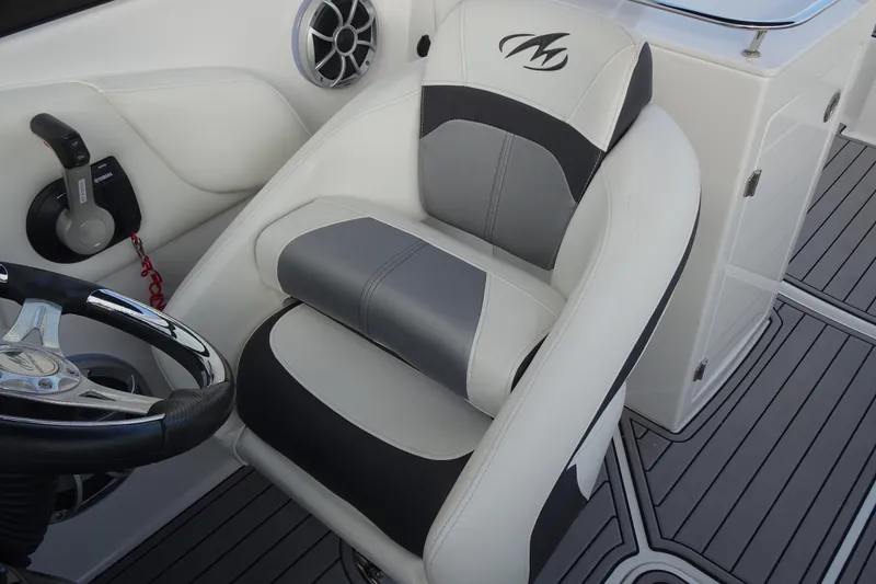 Slide: The Image of Captain's seat of a 2017 Monterey M-65 boat with steering wheel and controls. - 19