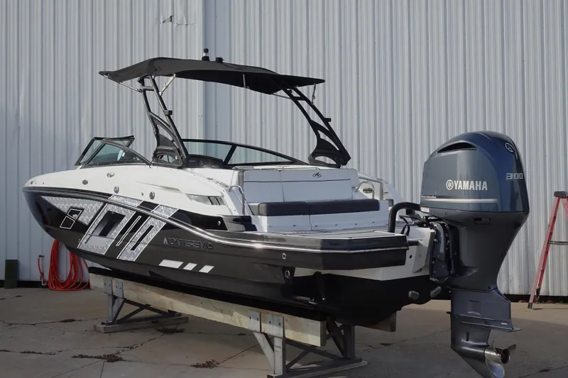 Slide: The Image of 2017 Monterey M-65 boat with Yamaha 300 engine, docked outdoors. - 2