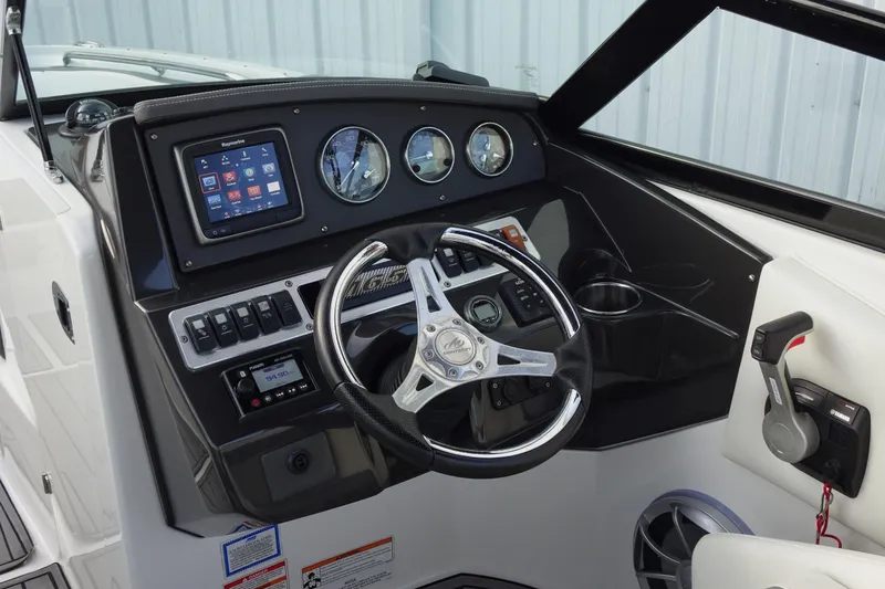 Slide: The Image of Cockpit of 2017 Monterey M-65 boat with steering wheel, gauges, and control panel. - 21