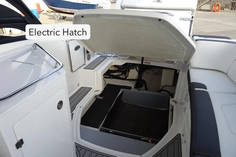 Slide: The Image of 2017 Monterey M-65 boat with open electric hatch, showcasing interior storage space. - 28