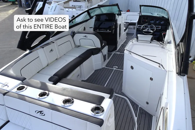 Slide: The Image of Luxurious 2017 Monterey M-65 boat interior with sleek seating and modern dashboard. - 7
