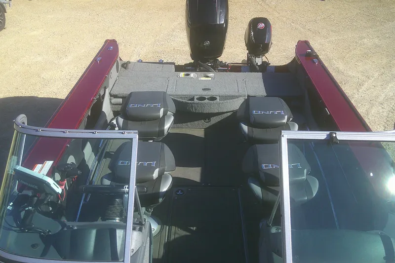Slide: The Image of 2017 Lund 1875 Crossover XS boat interior with seating and motor, viewed from above. - 13