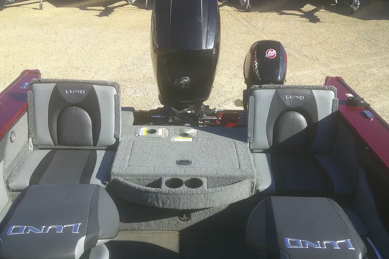 Slide: The Image of 2017 Lund 1875 Crossover XS boat interior with seating and Mercury outboard motor. - 20