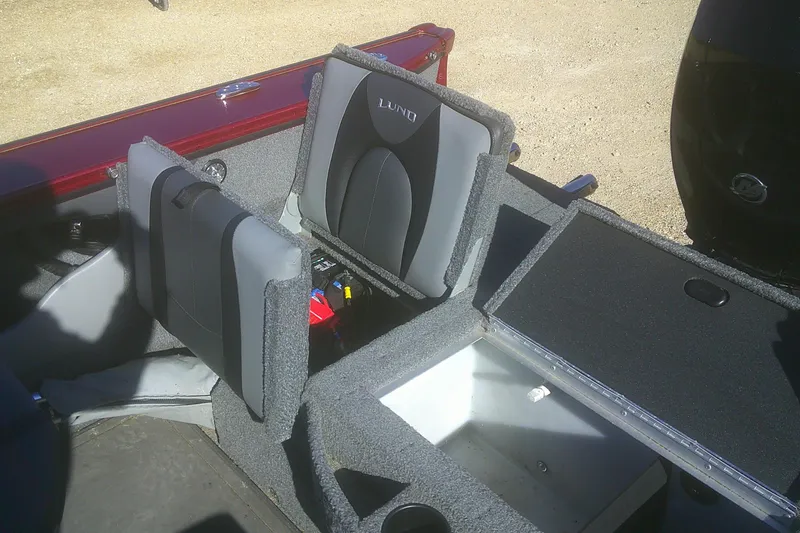 Slide: The Image of 2017 Lund 1875 Crossover XS boat interior with foldable seats and storage compartments. - 21