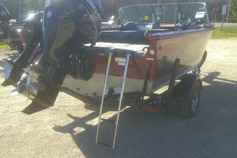 Slide: The Image of 2017 Lund 1875 Crossover XS boat with Mercury outboard motor and ladder on trailer. - 23