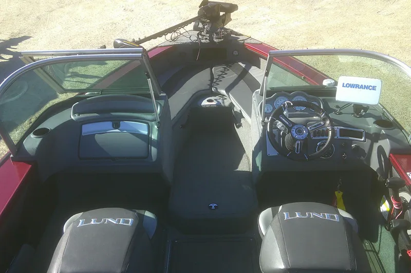 Slide: The Image of 2017 Lund 1875 Crossover XS boat interior with steering wheel and Lowrance equipment. - 5