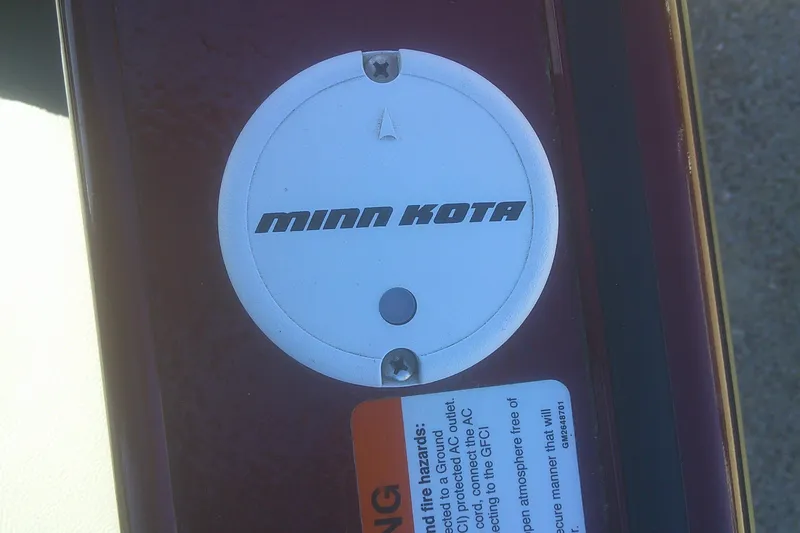 Slide: The Image of Minn Kota plug on 2017 Lund 1875 Crossover XS boat, with safety warning label. - 8
