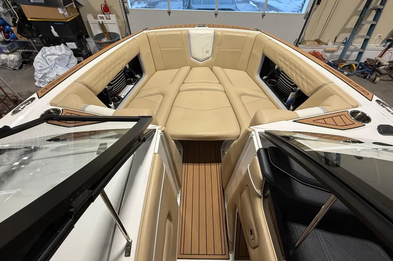Slide: The Image of 2020 Nautique Super Air Nautique G21 boat interior with tan seating and wood accents. - 10