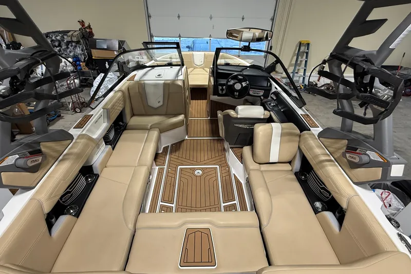 Slide: The Image of 2020 Nautique Super Air Nautique G21 interior with beige seating and wood accents. - 3