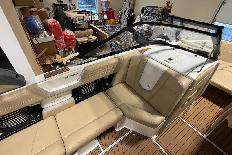 Slide: The Image of Interior of a 2020 Nautique Super Air Nautique G21 boat with tan seating. - 8