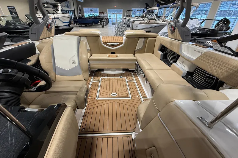 Slide: The Image of 2020 Nautique Super Air Nautique G21 interior with tan seating and wood-style flooring. - 9