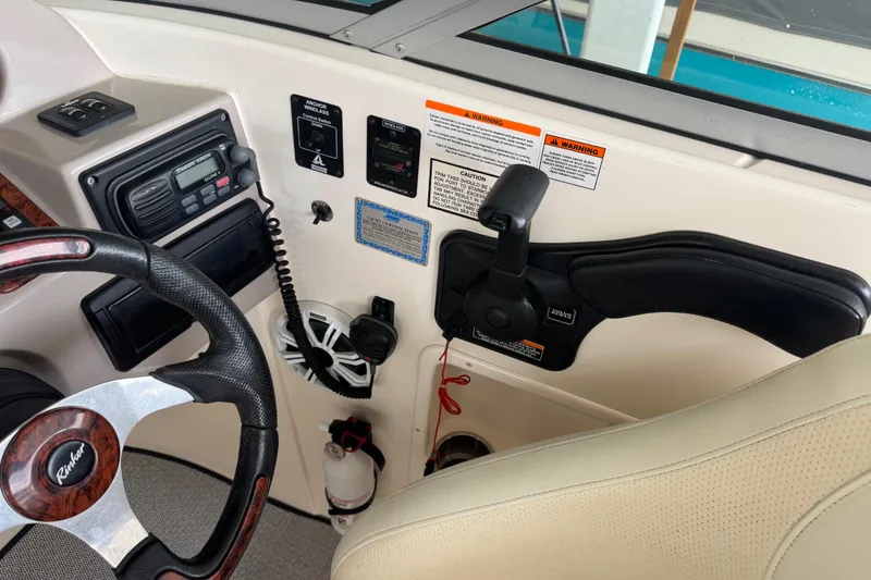 Slide: The Image of 2006 Rinker 282 Captiva Bowrider helm with steering wheel and control panel. - 10