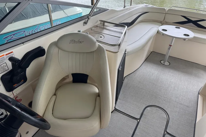 Slide: The Image of 2006 Rinker 282 Captiva Bowrider interior with helm seat and seating area. - 11