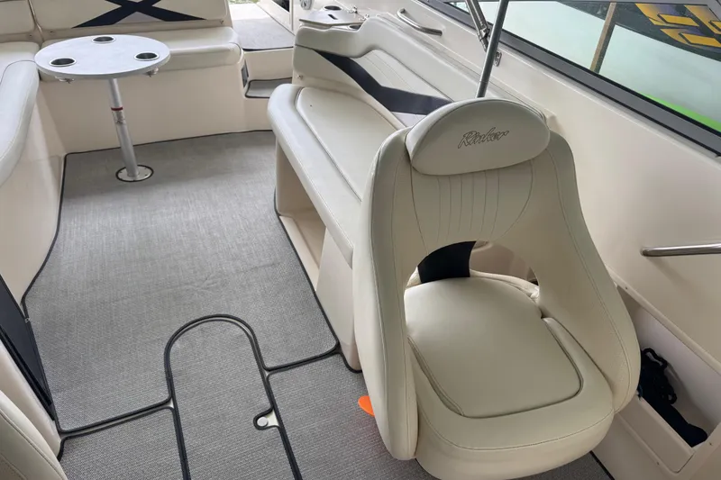 Slide: The Image of Interior of a 2006 Rinker 282 Captiva Bowrider with seating and table. - 12