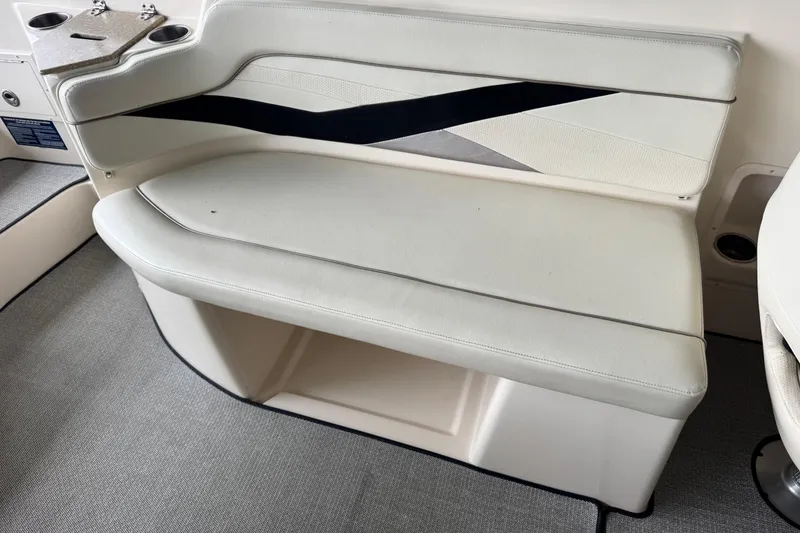 Slide: The Image of 2006 Rinker 282 Captiva Bowrider interior seating with cup holders and stylish upholstery. - 16