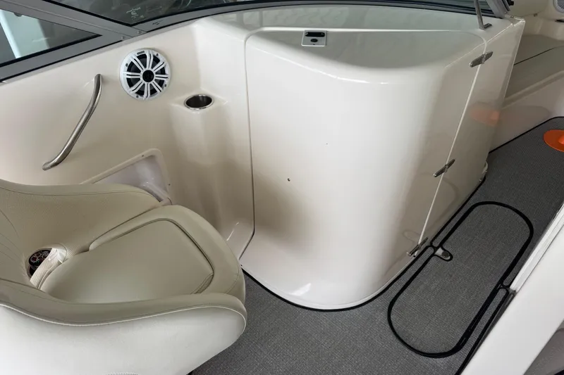 Slide: The Image of 2006 Rinker 282 Captiva Bowrider interior with seating, speaker, and storage compartment. - 17