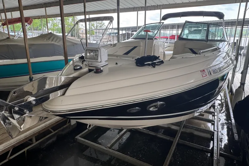 Slide: The Image of 2006 Rinker 282 Captiva Bowrider boat docked in a covered marina. - 2