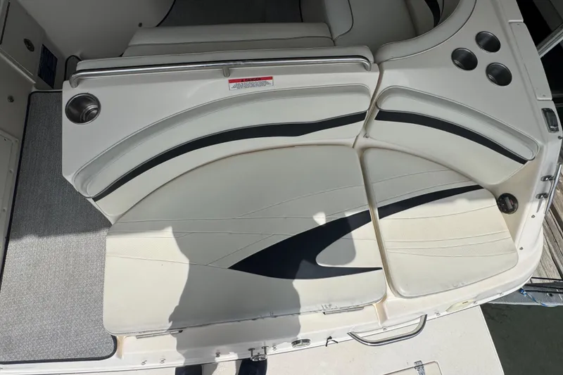 Slide: The Image of 2006 Rinker 282 Captiva Bowrider seating area with cup holders and stylish upholstery. - 28