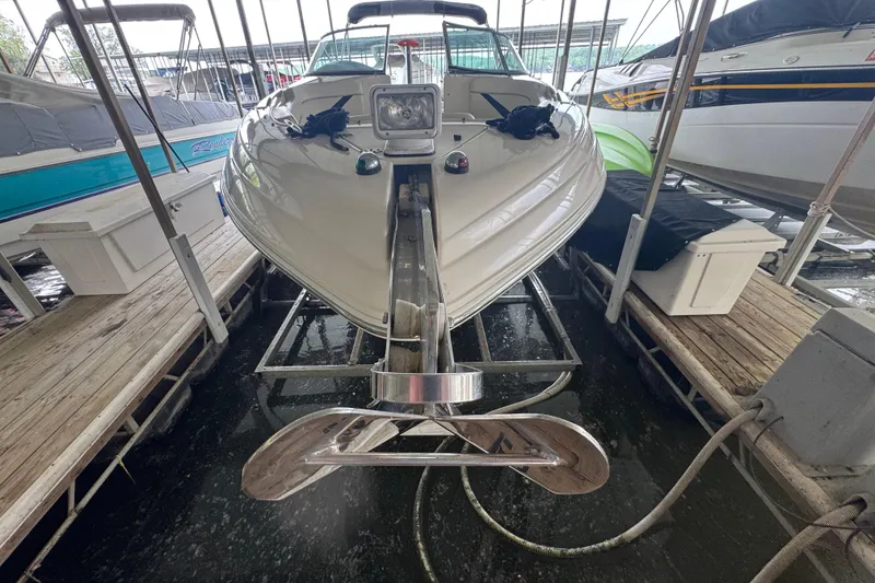 Slide: The Image of 2006 Rinker 282 Captiva Bowrider docked in a marina, front view. - 3