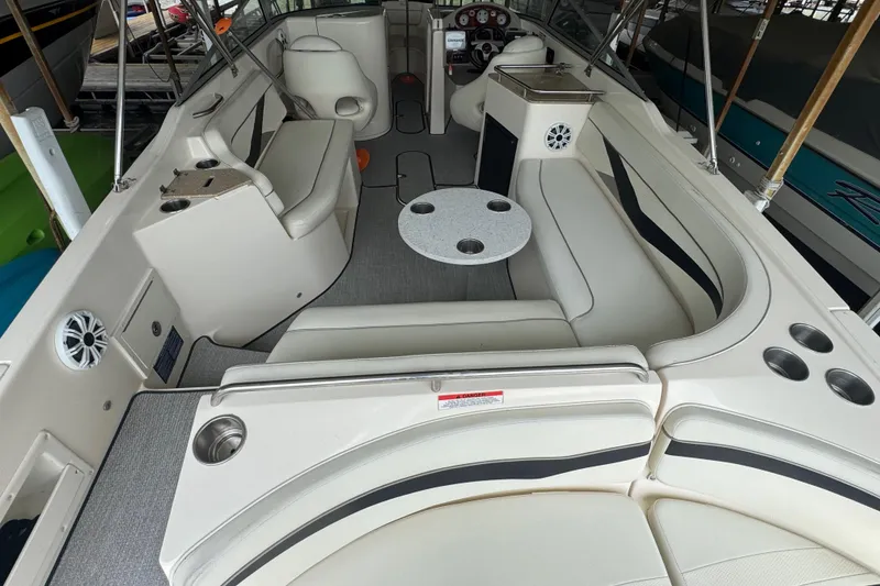 Slide: The Image of 2006 Rinker 282 Captiva Bowrider interior with seating, table, and cup holders. - 6