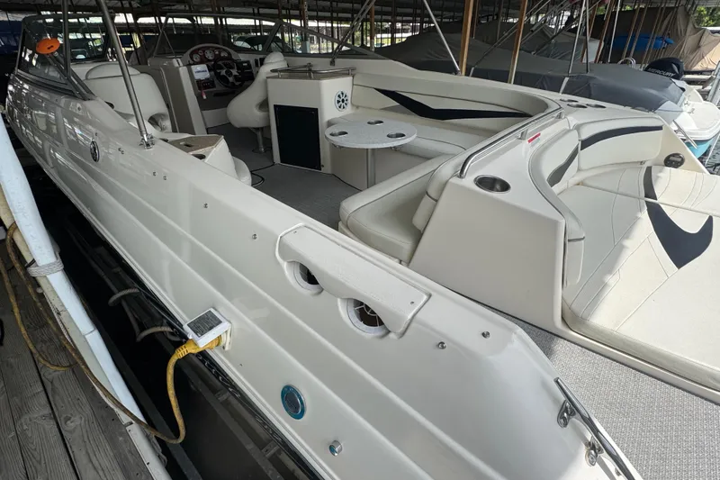 Slide: The Image of 2006 Rinker 282 Captiva Bowrider interior with seating and helm, docked in marina. - 7