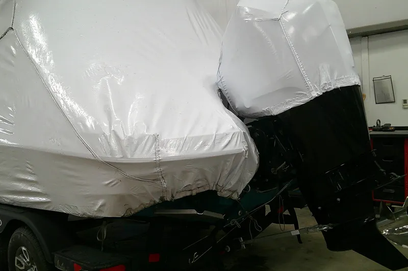 Slide: The Image of 2026 Tahoe 2150 CC boat covered in protective wrap, stored indoors. - 10