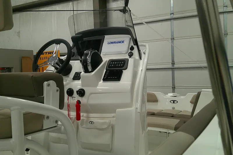 Slide: The Image of 2026 Tahoe 2150 CC boat console with steering wheel and navigation equipment. - 13
